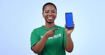 Volunteer, pointing and phone green screen, presentation mockup and climate change information or marketing in studio. Face of African person, mobile and eco friendly volunteering on blue background