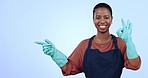 Happy black woman, housekeeper and pointing for advertising cleaning service against a studio background. Portrait of African female person, maid or domestic showing information on mockup space