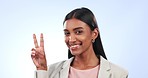 Face, peace and business woman with sign in studio for winning, vote or celebrate success on blue background. Portrait, indian worker and show v icon, thanks and emoji for support, review or feedback