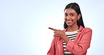 Pointing, happy and face of woman in studio with mockup for marketing, promotion or advertising. Smile, portrait and Indian female model with show hand gesture by white background with mock up.