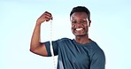 Black man, bodybuilder measuring muscle and progress in fitness, bicep and strong athlete on blue background. Happy, portrait and exercise with bodybuilding, training and check results in studio