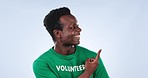 Smile, face and man volunteer with hand pointing in studio for faq, checklist or sign up info on blue background. Happy, portrait and African activist with how to guide, presentation or NGO platform