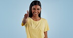 Happy woman, smile and thumbs up in success, good job or winning against a blue studio background. Portrait of excited female person showing like emoji, yes sign or OK for positive mindset or agree