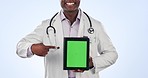 Doctor hands, tablet green screen and man pointing at website logo, clinic info or medical studio presentation. Cardiology results, mockup data space and African surgeon show news on blue background