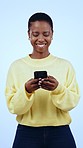 Typing, smile and black woman with phone in studio for conversation, online chat and social media. Communication, network and person on smartphone for contact, text and connection on blue background