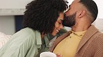 Black couple, kiss and hug on sofa for happy love, care or comfort while bonding together at home. Man kissing woman on forehead with smile for couple affection and relaxing on living room couch