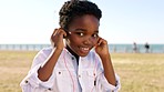 Kid portrait, headphones and music of a child outdoor on summer holiday listening and dancing to radio. 5g audio streaming, happy and young person with freedom and happiness hearing African track