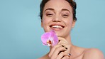Skincare, beauty and face of woman with flower on blue background for wellness, self care and luxury. Spa aesthetic, orchid and portrait of girl for cosmetics, natural beauty products and makeup