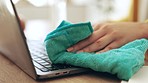 Closeup, woman and cleaning laptop keyboard with cloth for hygiene, coronavirus risk and bacteria protection. Female hands wipe dust on computer, health maintenance and safety of tech disinfection 