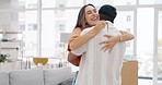 Keys, new house and happy couple hug in home, property or real estate goals of residential investment. Excited young woman hugging man to celebrate moving in with key, building mortgage or relocation