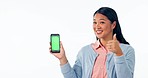 Happy asian woman, phone green screen and thumbs up in success or advertising against a studio background. Portrait of female person smile, like emoji or yes showing mobile smartphone app or display