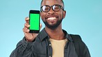 Green screen, phone and face of black man in a studio with mockup for marketing or advertising. Tracking markers, chroma key and portrait of African male model with cellphone by blue background.