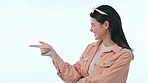 Thinking, space and smile with a woman pointing on a blue background in studio for inspiration. Idea, wow or surprise with a happy young person looking excited by a memory or eureka moment on mockup