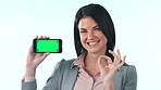 Okay, business woman and green screen of cellphone, space and agreement in studio on white background. Portrait, happy worker and yes emoji for mobile tracking markers, certified information and deal