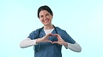 Healthcare, smile and a heart hands with a nurse pointing at you in studio on a blue background for care. Portrait, medical vote and cardiology with the choice of a happy young medicine profession