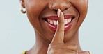 Secret, face and mouth of happy woman with finger on lips  for sign of privacy, confidential news and surprise in studio. Closeup, emoji and quiet for gossip, deal or whisper icon on white background