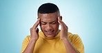 Stress, headache and young man in a studio with temple massage, sickness or mental health. Burnout, migraine and male model from Mexico with fail, mistake or crisis expression by blue background.