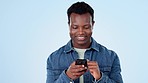 Happy black man, phone and laughing for funny joke, social media or meme against a studio background. African male person smile on mobile smartphone for fun research, chatting or texting on mockup