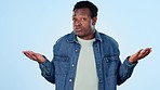 Hands, confused and choice with a black man on a blue background in studio for decision or options. Portrait, smile and doubt with a happy young person holding a selection in his palm for comparison