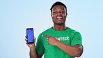 Man, volunteering and phone screen for marketing presentation, join us or sign up to volunteer in studio. Face of African person speaking of NGO mobile mockup or nonprofit contact on blue background