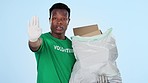 Man, volunteer and cleaning plastic for waste, green and activism for littering, sustainability and trash. Climate change, plastic or blue studio background for pollution, recycle or  accountability
