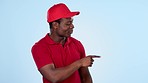 Courier man, pointing or studio for choice, decision or speaking of offer on blue background. Face of African delivery guy, you or sign for review for post service, shipping or ecommerce distribution