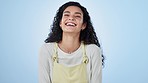 Smile, woman and laughing in studio, face with positive attitude and funny on blue background. Comic, young gen z model in a portrait and mockup space with joke or humor, happiness and freedom