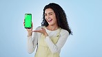 Face, happy woman or advertising green screen of phone, space or thumbs up for agreement, offer or deal on blue background. Portrait, mobile and yes to announcement, newsletter or promotion in studio