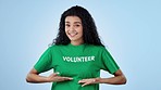 Volunteer, invite and face of woman on blue background for charity, donation and community service. Happy, excited and portrait of person with t-shirt for volunteering, NGO project or help in studio