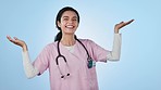 Options, decision and face of woman nurse in studio with mockup space for marketing or advertising. Happy, smile and portrait of female medical worker with comparison hand gesture by blue background.