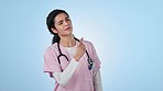 Pointing, doctor and woman with doubt, confused and thinking on a blue studio background. Person, nurse and medical professional with gesture, mindset and healthcare with questions or problem solving
