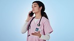 Phone call, nurse and woman on blue background for telehealth, online consulting and communication. Healthcare, networking and person on smartphone for medical service, help and advice in studio