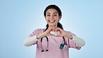 Nurse, heart hands and support, woman and health with wellness, feedback and gesture on blue background. Healthcare, help and emoji, review or opinion with cardiology and smile in portrait in studio