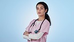 Healthcare, agreement face of woman doctor with arms crossed confidence in studio on blue background. Hospital, portrait and proud nurse with attitude, mindset and yes, expression or health advice