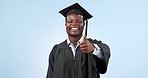 Face, thumbs up and black man with graduation, feedback and achievement on a blue studio background. Portrait, student or African person with degree, support and model with hand gesture or excellence