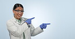 Presentation, scientist and woman pointing at mockup, advertising and smile in studio isolated on a blue background. Portrait, science and medical worker marketing research, promo space or show info