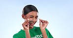 Wink, volunteer and face of a woman with glasses while working on a studio background. Flirty, happy and portrait of a young charity employee with eyewear, laughing and an entrepreneur smile