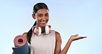 Mockup, fitness and face of a woman with a gesture to space for training information or promo. Happy, showing and portrait of an Indian girl or athlete with gym marketing on studio background