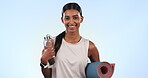 Indian woman, gym and yoga with mat, water and hydration with exercise on blue background. Fitness, pilates and training with smile in portrait, liquid in bottle for thirst and health in studio