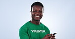 Volunteer face, phone and happy black man on charity outreach website, community service blog or NGO social media. Cellphone, recycling support and studio portrait of eco activist on blue background