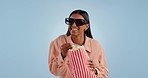 Funny, 3d glasses and woman with popcorn, movie and entertainment on a blue studio background. Person, girl and model with cinema snack, eyewear and streaming a film with humor, comedy and laughing