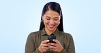 Asian woman, smartphone and texting with smile, laughing and on blue studio background. Social media, streaming and communication with memes, funny and comic for conversation, mobile games and chat