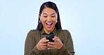 Phone, surprise news or business woman celebration, cheers and reading online success goals, report or data. Winner achievement, cellphone or studio person with income notification on blue background