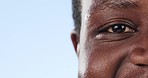 Closeup, man and eye with optometry, mockup space and smile on a blue studio background. Zoom, African person and model with health, clear vision and face with iris, looking and see with wellness