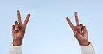 Closeup, person and hands with peace, sign and support with agreement, respect and review on a blue studio background. Model, mockup space and fingers with feedback, vote and emoji with icon and like