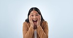Surprise, face and business woman with announcement, winner and celebration with news in studio. Winning, promotion and excited with wow from achievement of a female entrepreneur with blue background