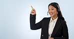 Face, pointing and woman with telemarketing, promotion and call center on a white studio background. Portrait, person and model with hand gesture, telecom sales and customer service with tech support