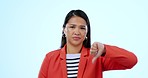 Thumbs down, upset and face of woman in a studio with disappointed, disagreement or bad hand gesture. Mad, portrait and young Asian female model with negative expression isolated by white background.