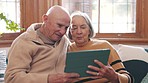 Tablet, conversation and senior couple in living room networking on social media or mobile app together. Happy, love and elderly man and woman in retirement scroll on internet with digital technology