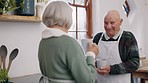 Coffee, conversation and senior couple in kitchen for communication, talking and bonding together. Happy, discussion and elderly man and woman in retirement speaking and drinking cappuccino at home.